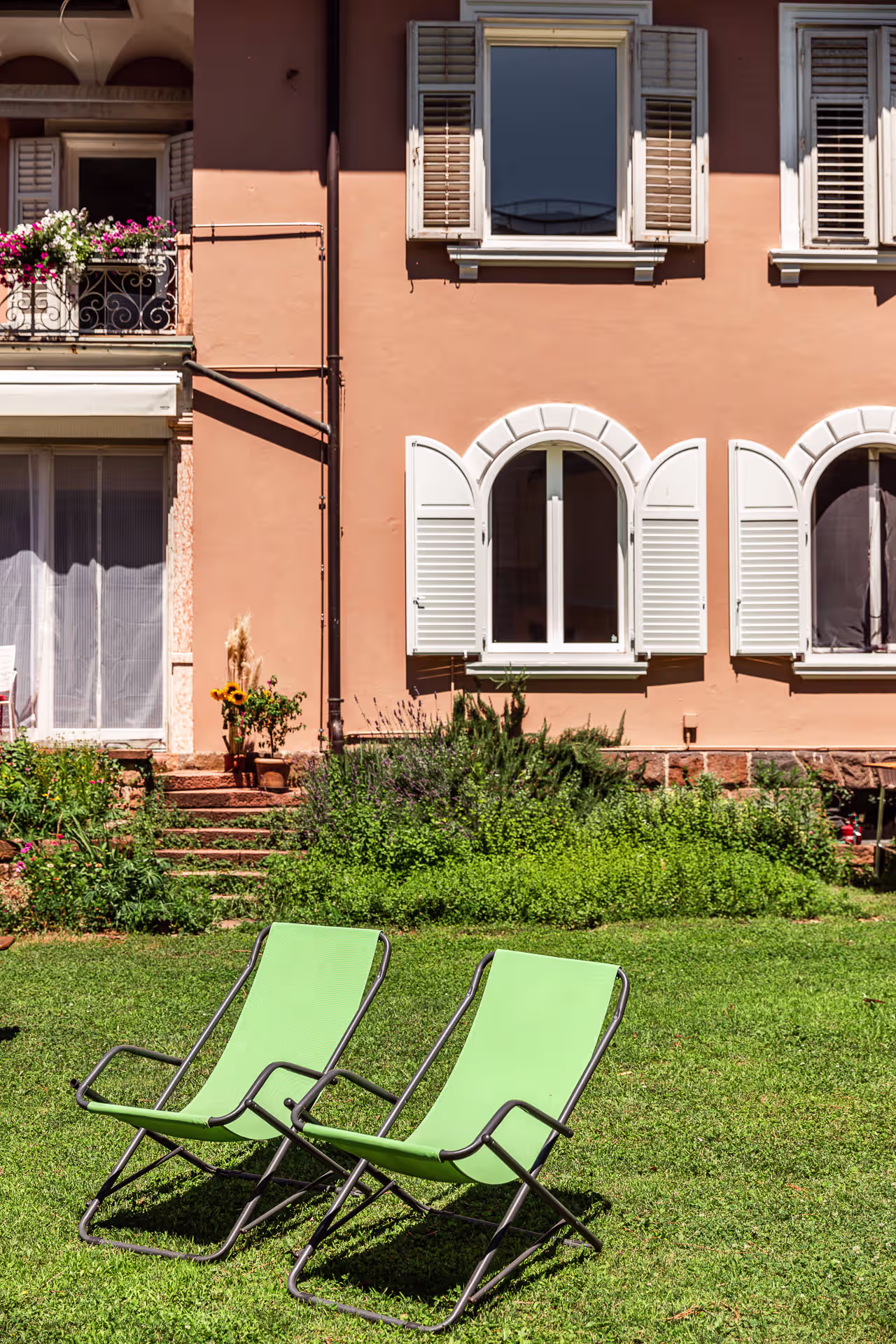 Two green deckchairs in the garden